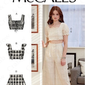May include: Sewing pattern for a cropped top and wide-leg pants. The pattern includes three different styles of tops: a square neck top with a ruffle, a square neck top with a tie, and a square neck top with a ruffle and a tie. The pants are wide-leg and have a high waist. The pattern is for sizes 12-14-16-18-20. The pattern is from McCall's and the pattern number is M7962.