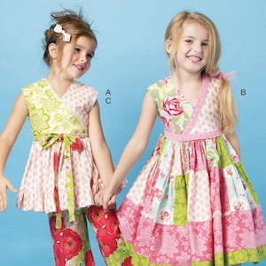 May include: Two young girls wearing colorful floral outfits. One girl wears a pink and green floral top with matching pants. The other girl wears a patchwork dress with pink, green, and blue floral patterns. The image has the text "McCALL'S" at the top.