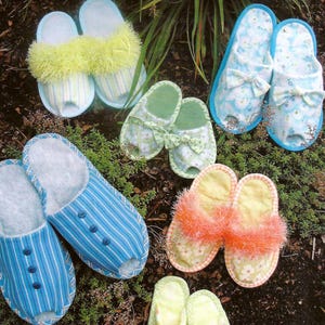 May include: A variety of colorful, handmade slipper designs. The slippers feature different patterns, including stripes, floral prints, and fluffy accents. The text "Favorite Things Pattern Designs" and "Sole Comfort" are visible.