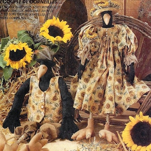 May include: McCall's Crafts pattern for crow dolls. The pattern includes instructions for making Mr. and Mrs. Crow, each approximately 24 inches tall. The dolls are dressed in sunflower-themed outfits and are surrounded by sunflowers and hay.