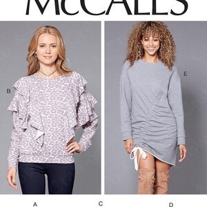May include: McCall's sewing pattern M7688 featuring various women's tops and dresses. Designs include a leopard print top with ruffles, a gray ruched dress, a floral print top, a teal hoodie, and a pink dress with ruffles.