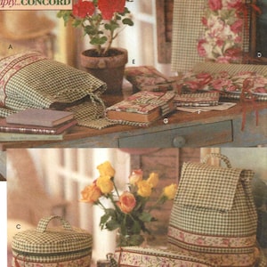 May include: Simplicity Crafts pattern featuring various fabric craft projects. The image showcases a backpack, cosmetic bag, and other items with a green and white checkered pattern, accented with floral trim. A potted rose plant and a bouquet of yellow roses are also visible.