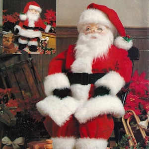 May include: A Vogue Patterns 7321 sewing pattern envelope featuring a Santa Claus doll wearing a red suit with white faux fur trim, a black belt, and a matching hat. The cover displays the text Vogue Patterns 7321 One Size and Designed by Linda Carr.