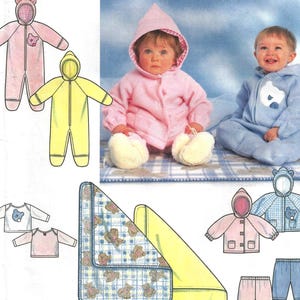 May include: Simplicity sewing pattern for baby clothing, featuring a pink hooded jumpsuit with bear ears, a yellow jumpsuit, and a blue jumpsuit. The pattern includes illustrations of the finished garments and a blanket with a teddy bear pattern.