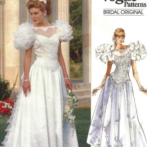 May include: A white bridal gown with a long train, featuring a fitted bodice with intricate detailing and voluminous, ruffled sleeves. The Vogue Patterns image also shows a sketch of the dress. The pattern is labeled "ADVANCED/PLUS DIFFICILE" and pattern number 2398.