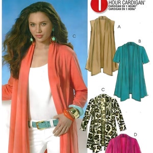 May include: An Easy McCall's M6084 sewing pattern envelope for a 1 Hour Cardigan in size Y. The front features a coral long-sleeved cardigan, while the right side displays four illustrations of the garment in tan, teal, leopard print, and magenta.