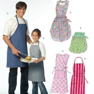 May include: McCall's Fashion Accessories sewing pattern envelope featuring illustrations of five different apron styles. Designs include a solid blue apron, a floral print apron with lace trim, a green and yellow plaid half-apron, and striped aprons.