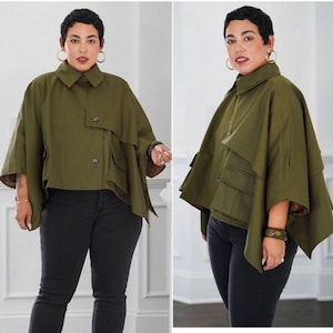 May include: Olive green cape-style jacket with a button closure and pockets, paired with black jeans. The image includes the text "S9893" and "Simplicity". A DIY & Lifestyle Brand.