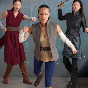 May include: Simplicity sewing pattern 8718 R5 featuring costume designs. The pattern includes options for a dress, vest, jacket, and skirt. The image shows models wearing the costumes. The pattern size is U.S. 14-22.