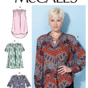 May include: McCall's sewing pattern M7324 features four different blouse and tunic designs. The image shows a woman wearing a long-sleeved blouse with a colorful, intricate pattern. The pattern includes sizes A5 (6-8-10-12-14).