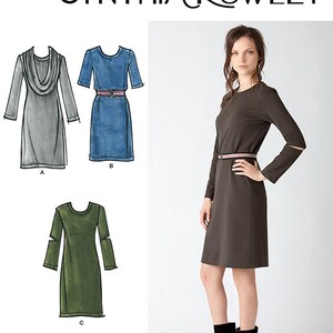 May include: A sewing pattern for a dress with three different styles. The pattern is for a simple, fitted dress with long sleeves and a round neckline. The dress can be made with a cowl neck, a denim fabric, or a solid color. The pattern is by Cynthia Rowley and is Simplicity pattern number 2054.