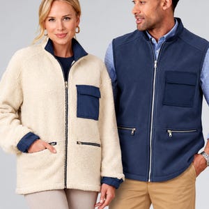 May include: A cream-colored sherpa fleece jacket with a full-length zipper, a dark blue chest pocket, and dark blue zippered side pockets. Beside it, a dark blue fleece vest with a full-length zipper, a chest pocket, and two zippered side pockets.