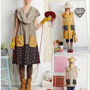 May include: Simplicity sewing pattern S9122 featuring three different dress designs. The dresses have floral and polka dot patterns, with details like pockets and short sleeves. The image includes the text "dottie angel" and "Designed and printed in USA."