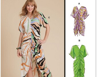 May include: A sewing pattern for a dress with three different view options. The dress has a gathered bodice and a flowing skirt. The pattern is printed in the USA.