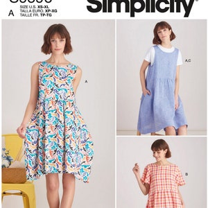 May include: Simplicity sewing pattern S9596 features three different dress designs. The main image shows a sleeveless dress with a colorful floral pattern. The pattern includes sizes XS-XL and is designed and printed in the USA.