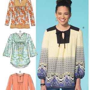 May include: McCall's M7284 sewing pattern featuring three blouse designs. The blouses have long sleeves and various necklines. One blouse is peach, another has a floral print, and the third has a geometric and paisley pattern with black and blue accents.