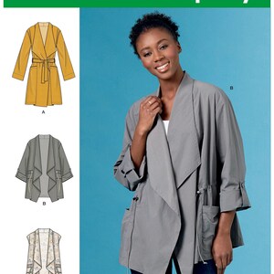 May include: Simplicity pattern S8989 features three different jacket designs. The image shows a woman wearing a gray jacket with pockets and drawstrings. The pattern includes sizes XXS-XXL. The Simplicity logo and "Since 1927" are visible.
