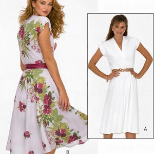 May include: A sewing pattern for a wrap dress featuring two variations: version A is a solid white dress with short sleeves and a V-neckline, and version B is a light purple dress with a floral print in green and dark red, both with belts.