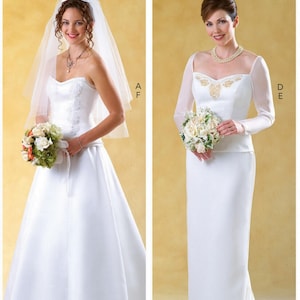 May include: Two white wedding dresses. The left dress is strapless with a sweetheart neckline, floral embroidery, and a veil. The right dress features long sheer sleeves, a square neckline with gold embroidery, and a column silhouette with a train.