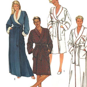 May include: Simplicity pattern featuring four different robe designs. The robes vary in color and style, including a long blue robe with white trim, a red plaid robe, and two white robes with red trim. The Simplicity logo is in the upper right corner.