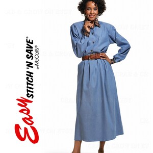 May include: A long-sleeved blue dress with a button-down front, a collar, and cuffs featuring a brown plaid pattern. The dress is cinched at the waist with a brown woven leather belt. The text EASY STITCH 'N SAVE by McCall's is visible.