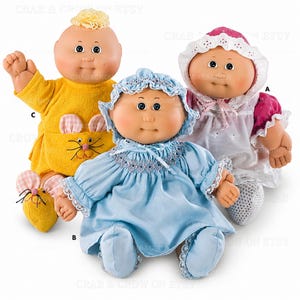 May include: Three dolls with round faces and yarn hair. One doll wears a yellow outfit with a mouse face and ears. Another wears a blue smocked dress with a matching bonnet and lace trim. The third doll wears a white dress with a pink bonnet.