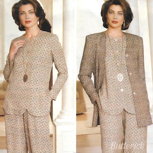 May include: A two-piece beige suit with a floral pattern, consisting of a long-sleeved top and matching pants. A long gold necklace with a leaf pendant is worn. A matching beige blazer is worn over the top in the second image.