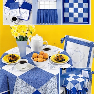 May include: A collection of blue and white kitchen textiles featuring teapot and teacup motifs. The set includes a checkered tablecloth, chair covers, curtains, and napkins. The fabric displays a mix of solid blue, floral, and white embroidered patterns.