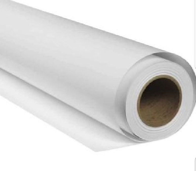May include: A white roll of paper, likely for printing or crafting, is rolled up and ready to be used.