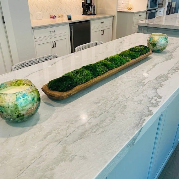 A 36" showstopper centerpiece: a hand-carved wooden bowl overflowing with preserved emerald moss — living sculpture energy without any watering required, and 183 hearts don't lie.