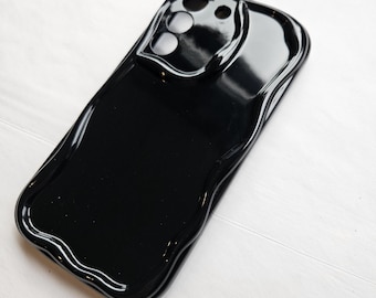 May include: Black phone case with a unique, melted design. The case has a raised camera bump with three cutouts for the lenses.