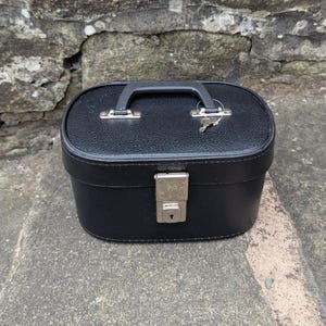 Beauty case vintage in pelle nera Hilmar Manchester, con interno in tessuto rosso, anni '60