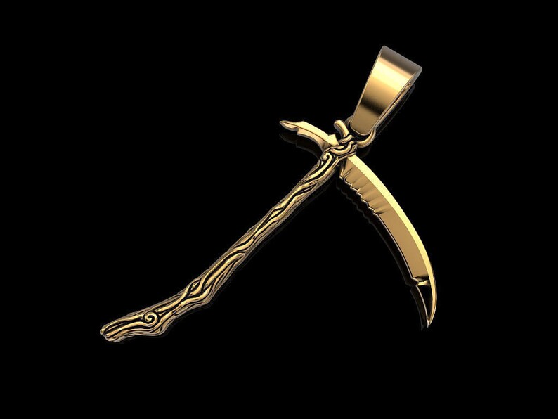 May include: A gold-colored pendant in the shape of a stylized sickle with a detailed design. The pendant has a loop at the top for attaching to a chain.