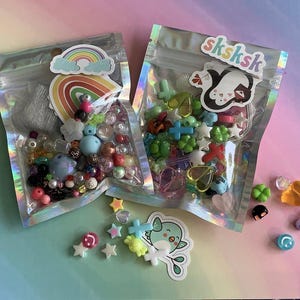 May include: A set of three ceramic mugs with a speckled, matte finish. The mugs are in shades of cream, light grey, and dark grey. Each mug has a simple, minimalist design and a rounded handle. Ideal for tea or coffee.