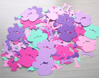 May include: A pile of colorful paper paw prints and bone shapes, perfect for a dog-themed party or craft project. The paw prints are in shades of pink, purple, and green, while the bones are white.