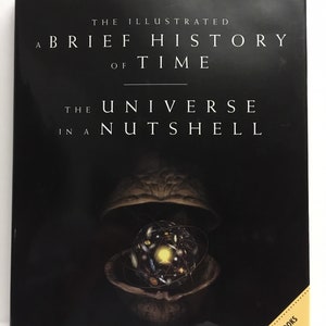 May include: A black book cover with the title "The Illustrated A Brief History of Time The Universe in a Nutshell" by Stephen Hawking. The cover features a graphic of a walnut shell with the universe inside.