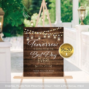 May include: A printable wedding sign with a rustic wood background and string lights. The sign reads "Tomorrow is going to be the best day ever!" and "Thank you for being here to celebrate!"