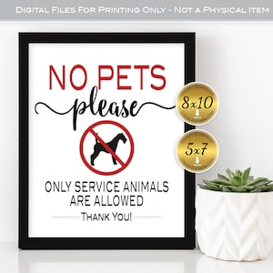 May include: A framed sign with the words "NO PETS please" in red and black. A graphic of a dog inside a red circle with a line through it is below the words. The sign also states "ONLY SERVICE ANIMALS ARE ALLOWED. THANK YOU!"