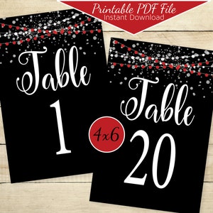 May include: Two printable table number cards with a black background and silver and red confetti. The text "Table" is in white cursive font. The table numbers are 1 and 20 in white. The size of the cards is 4x6 inches.