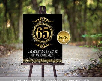 May include: A black and gold printable sign with the number 65 in a circle with gold glitter. The text "Celebrating 65 years of awesomeness!" is below the number. The sign is on a wooden easel.