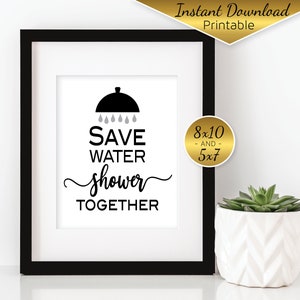 May include: Black and white printable sign with the text "Save Water Shower Together" and a silhouette of a shower head with raindrops. The sign is framed in black and is 8x10 inches.