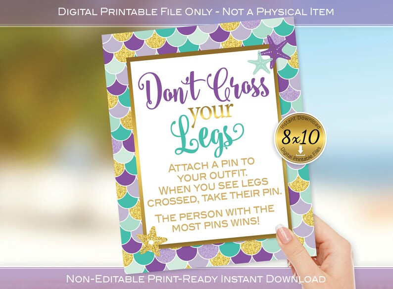May include: Printable 8x10 inch sign with a mermaid scale background in purple, teal, and gold. The sign says "Don't Cross Your Legs" and includes instructions for a game.