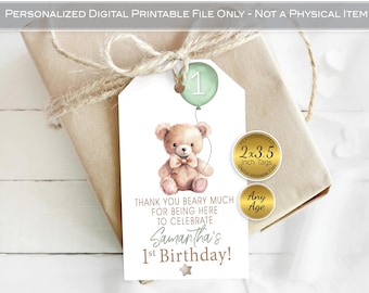 May include: A personalized birthday gift tag featuring a watercolor teddy bear holding a balloon with the number 1. The tag includes the text "Thank you beary much for being here to celebrate Samantha's 1st Birthday!" and is 2x3.5 inches.