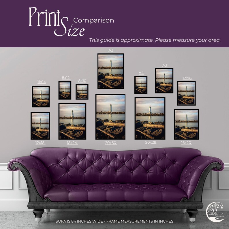 a purple couch sitting in front of a wall with pictures on it