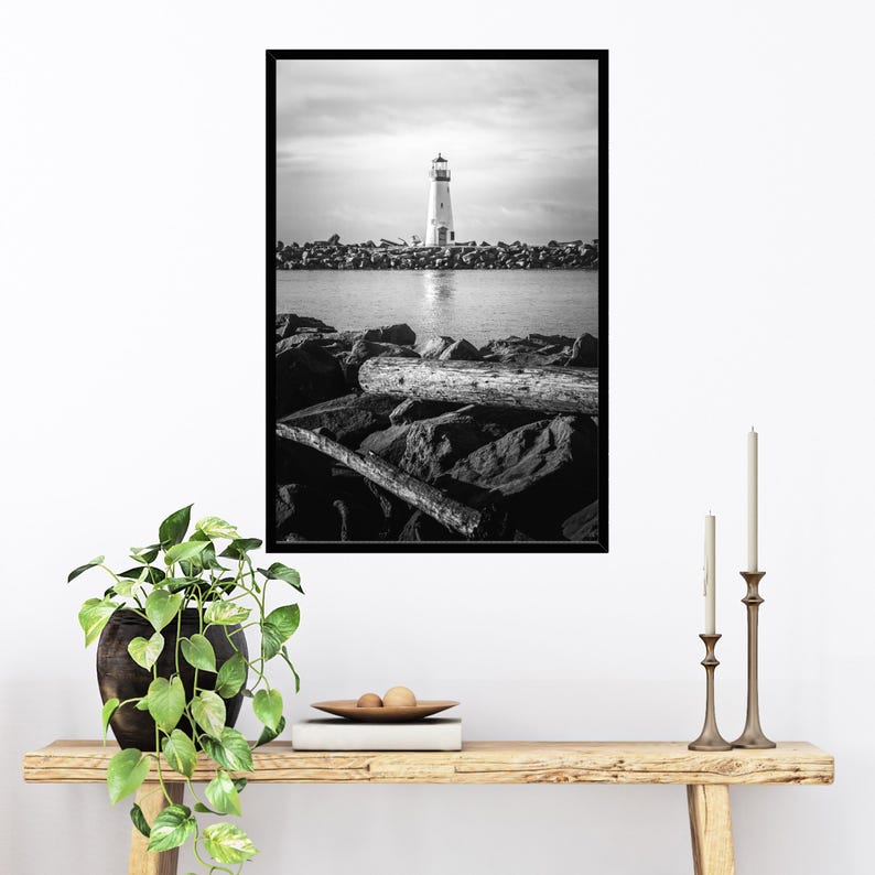 a black and white photo of a lighthouse in the distance