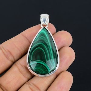 May include: A teardrop-shaped pendant with a green malachite stone set in sterling silver.