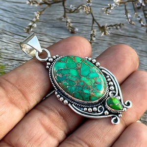 Handmade Pendant with Green Copper Turquoise set in 925 Sterling Silver. Oval shape with two turquoise stones, showcasing a refined design. Perfect for a wedding anniversary gift.