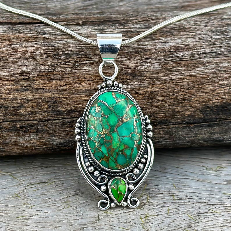 Handcrafted Green Copper Turquoise Pendant with two turquoise stones set in a smooth 925 Sterling Silver oval frame. A unique and thoughtful wedding anniversary gift for her.