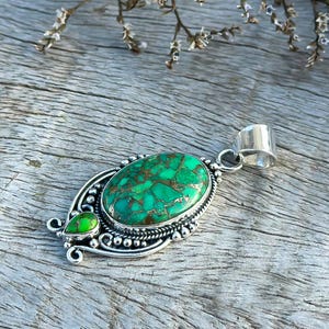 Elegant Handmade Green Copper Turquoise Pendant on a 925 Sterling Silver chain. Features a polished oval turquoise stone and a second turquoise stone for a sophisticated touch. A great anniversary gift.