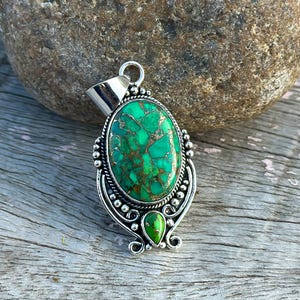 Handmade 925 Sterling Silver pendant with Green Copper Turquoise. Features a large oval turquoise stone alongside a smaller turquoise, designed for a wedding anniversary gift.